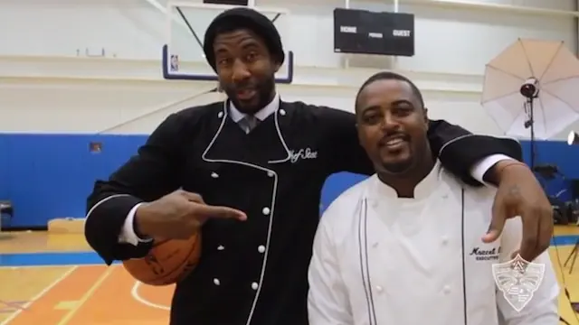 Amar'e Stoudemire in a chef's coat alongside a professional chef