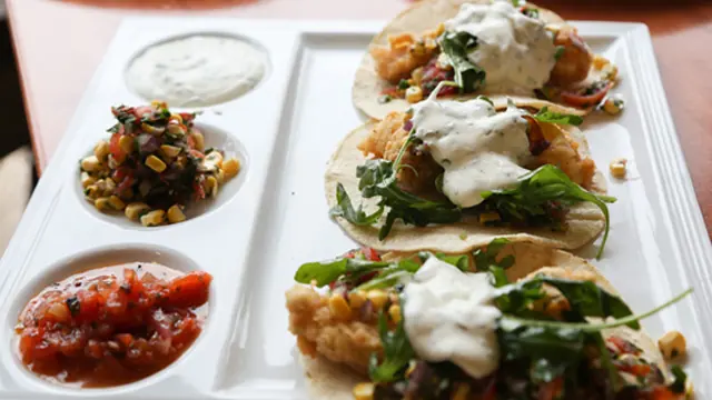 A plated dish with fresh salsa and greens