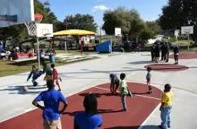 Children playing basketball on an outdoor community court