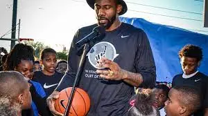 Amar'e Stoudemire with young people holding basketballs at a community event