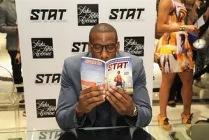 Amar'e Stoudemire holding a copy of his STAT book at a signing event
